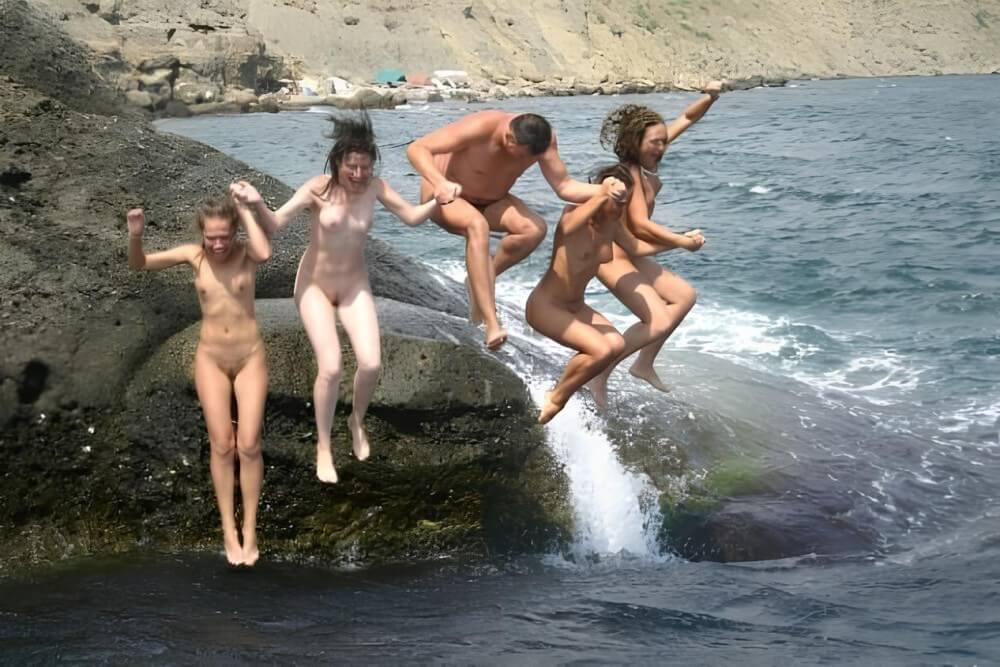 Mens and girls nudists on a beach - Peace and tranquility as goals of the naturist life