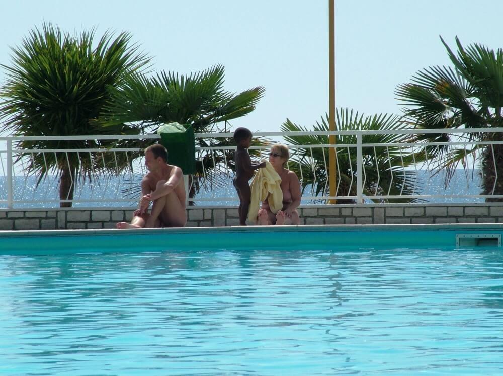 Photo of naturists in an outdoor pool - Nudism improves health and boosts self-esteem